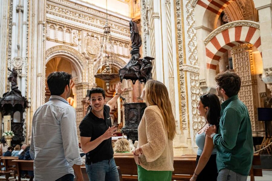 From Madrid: Córdoba Private Day Tour by High-Speed Train - La Judería: narrow streets, medieval atmosphere, and a guided lens